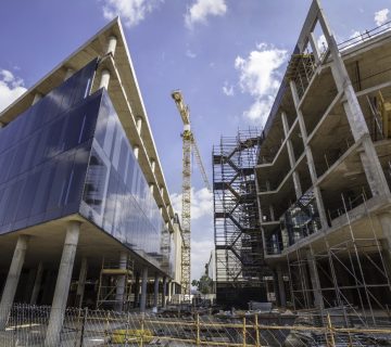 Construction expansion site with buildings and a crane 360x320