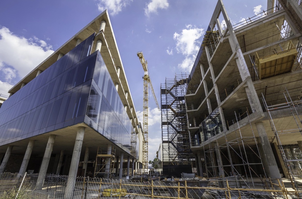 Construction expansion site with buildings and a crane